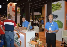 While Daniel Pollak with CarbAmericas talks to customers, Darrell Genthner shows palmer mangos from Brazil. They will be available for one more week. Genthner believes that soon many more countries will produce palmer mangos in lieu of Tommy Atkins.